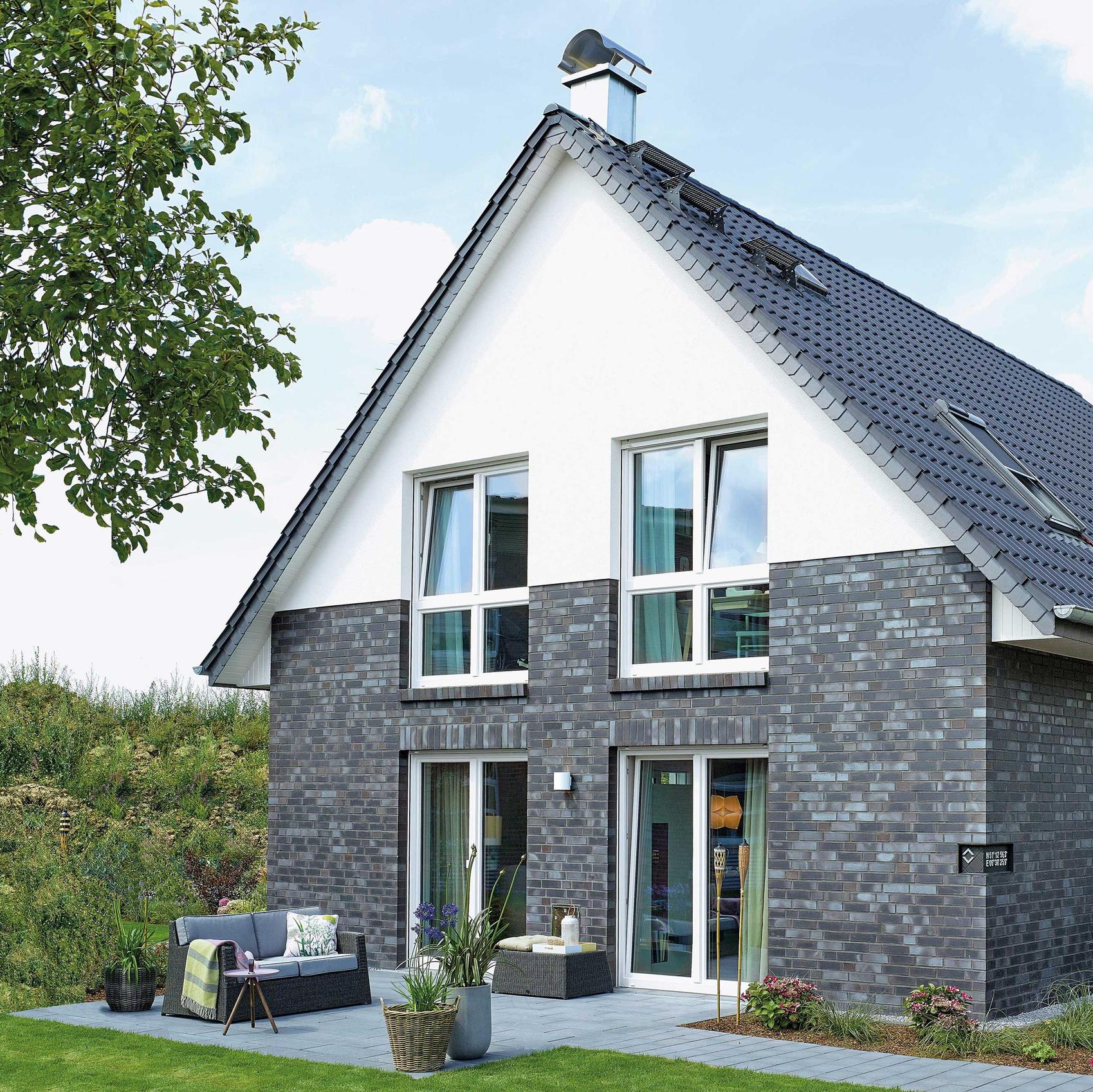 Modernes Einfamilienhaus mit großer Fensterfront und Garten. 