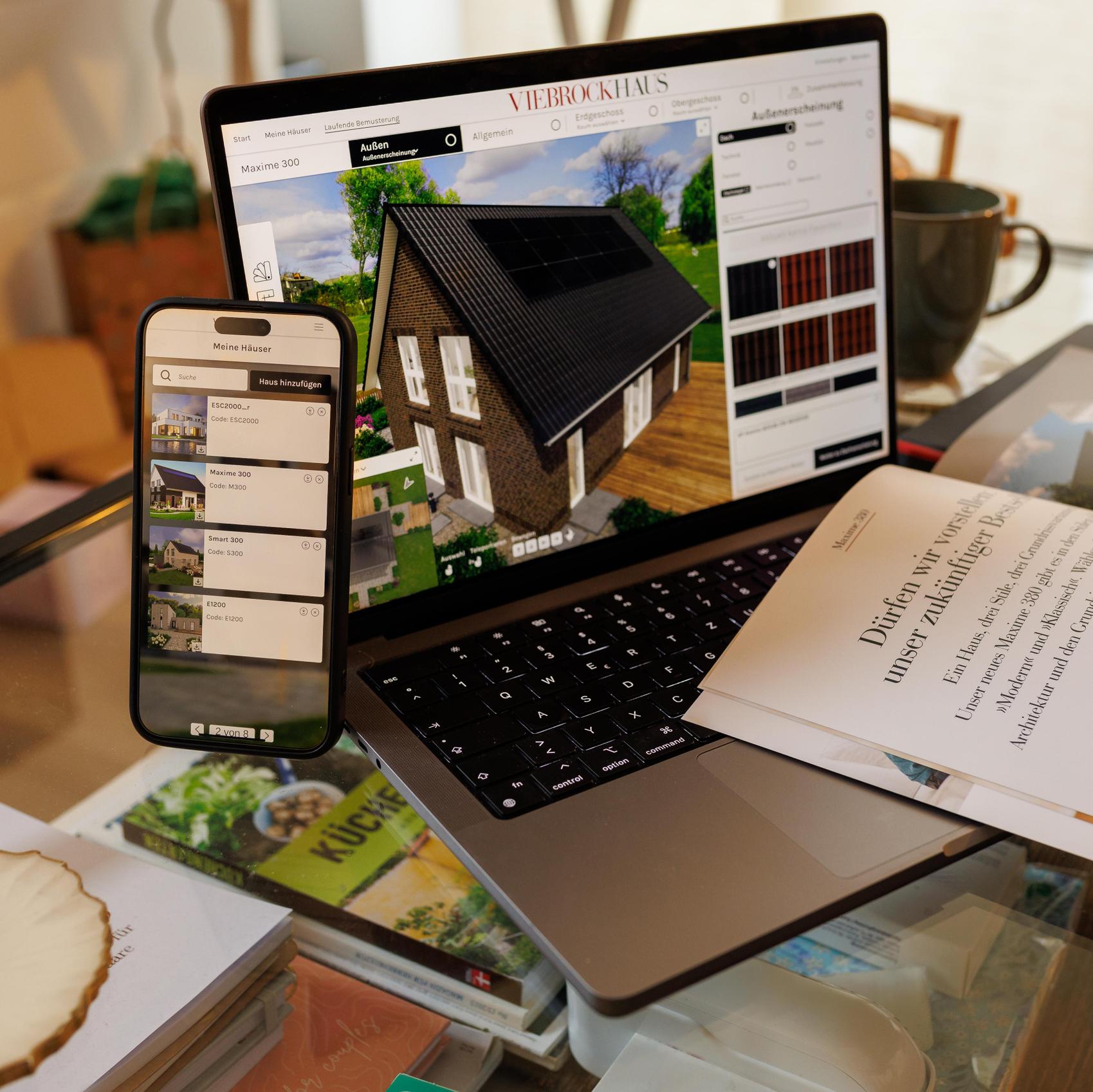 Viebrockhaus Designer-App auf dem Smartphone und einem Laptop-Bildschirm um Ihr Massivhaus zu bauen