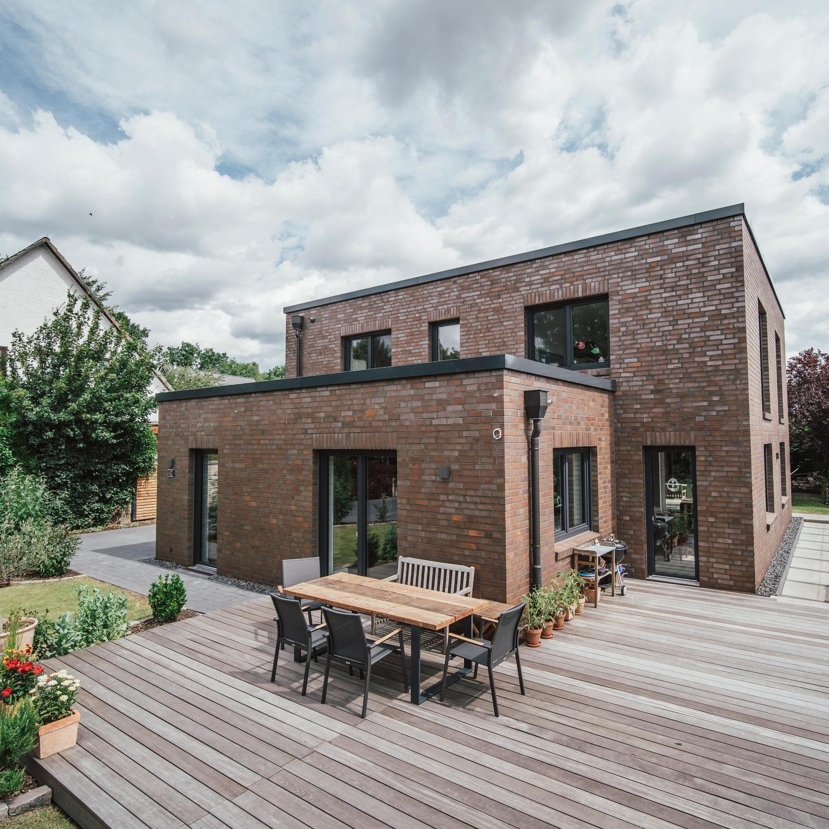 Flachdachhaus aus Klinker mit Holzterrasse